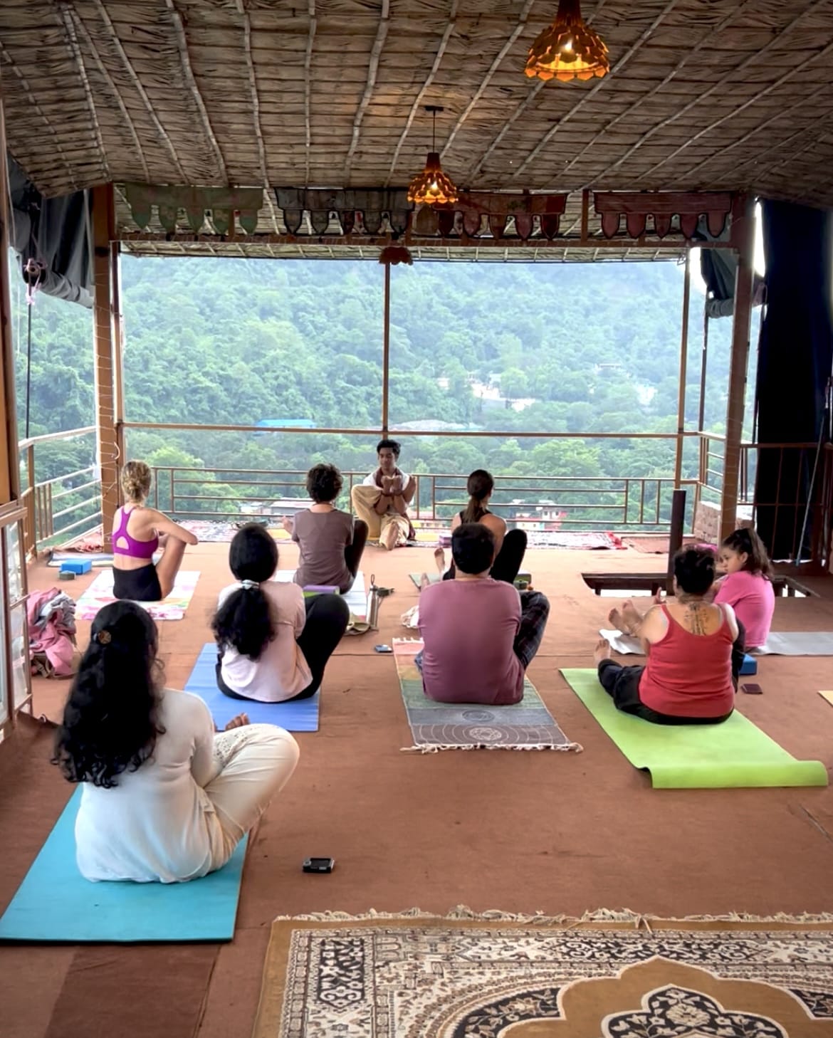 Yoga practice on a rooftop overlooking the Ganga in Rishikesh